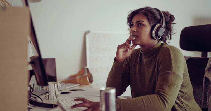 Woman at a desk wearing a headset